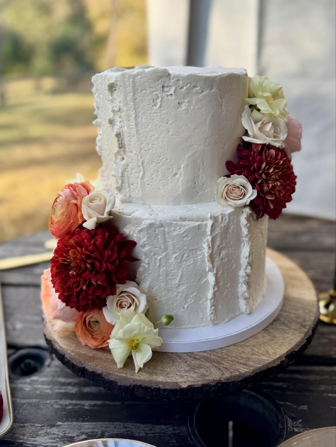 A stunning 2-tier rustic wedding cake with real flowers Emily made